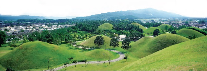 <B>Gyeongju Historic Areas.</B> Gyeongju was the capital of Silla for about one millennium. The city still contains a wealth of archaeological remains from the Kingdom, and hence is often dubbed as “a museum without walls or roof.†The photo shows a scene of the Silla mound tombs located in the city.
